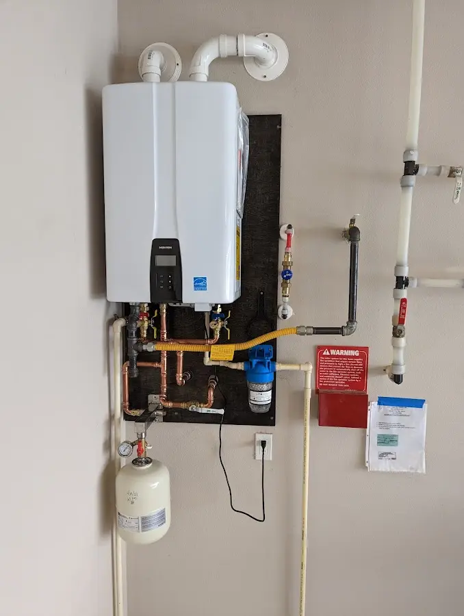 Professional plumber installing copper piping in a Waipio Acres home